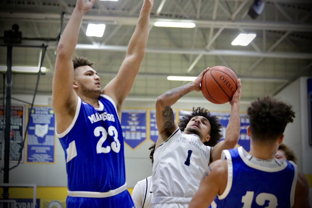 A Springfield High School basketball player tries to make a shot during a game against Miamisburg