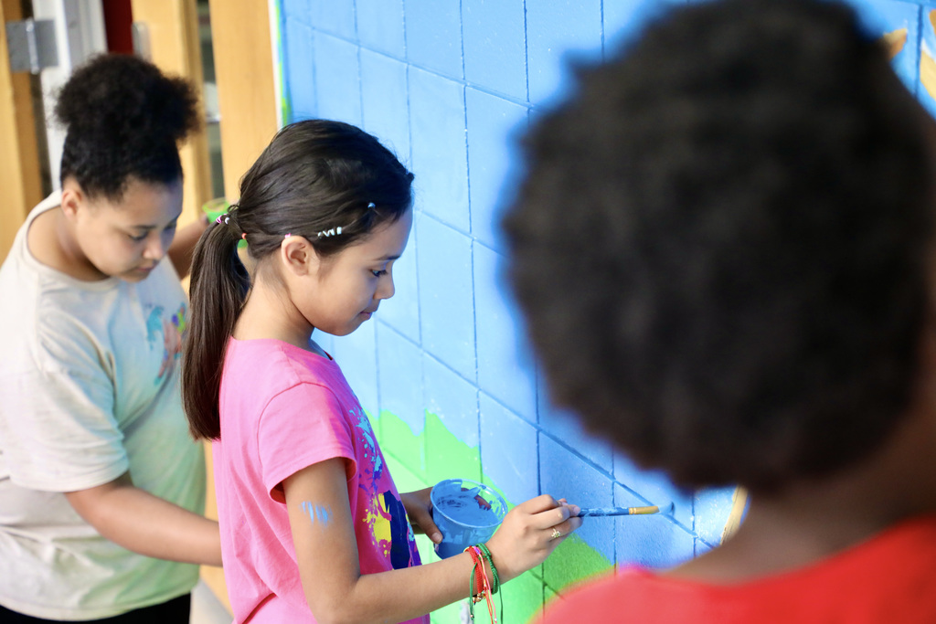3 Perrin Woods students work on the school's new tree mural in the main hallway